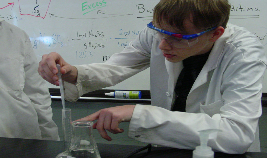 Cody Wilson measuring acid for a stoichiometry reaction. 3rd period 86% yield, 4th period 108% yield